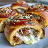 Twelve savory Irresistible High Protein Pepperoni Pizza Rolls stacked on a baking sheet, featuring lean beef and pepperoni tucked inside soft dough.