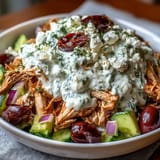 Bright Mediterranean Tzatziki Chicken Salad mixed with crisp cucumber, dill, and cherry tomatoes in a white bowl.