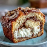 Freshly baked Cream Cheese Cinnamon Swirl Banana Bread with a crackly cinnamon sugar top and a soft center.