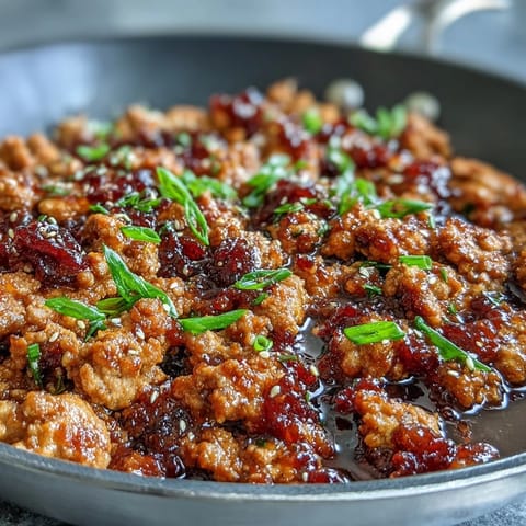 Golden-brown Korean-Style Ground Turkey simmering in a glossy, spicy-sweet sauce flecked with toasted sesame seeds and fresh chives.