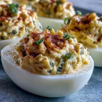 Creamy sweet pickle relish deviled eggs sprinkled with paprika.